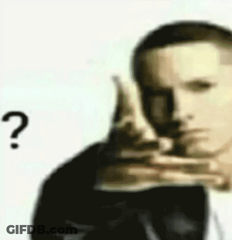 A Man In A Suit Is Pointing At Something With A Question Mark . GIF