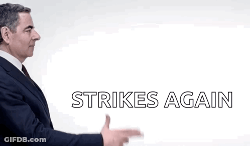 A Man In A Suit Is Pointing At Something With The Words Strikes Again Below Him GIF