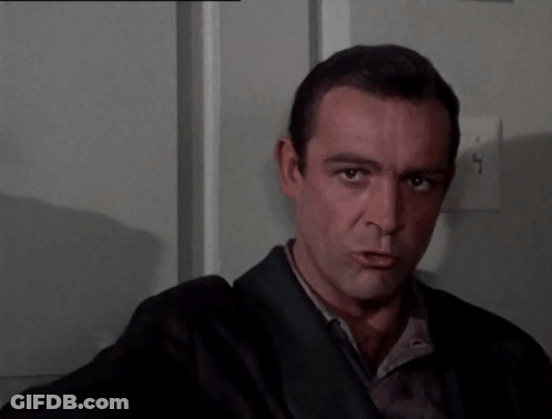 A Man In A Suit Is Pointing His Finger At The Camera GIF