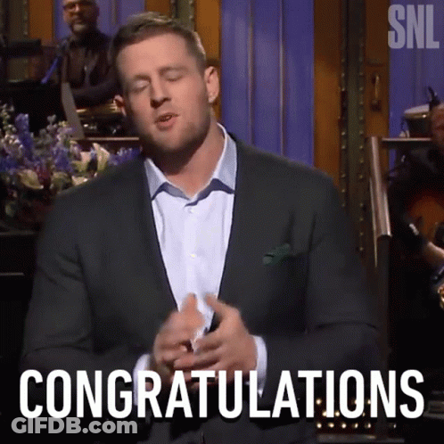 A Man In A Suit Is Saying Congratulations In Front Of A Band GIF