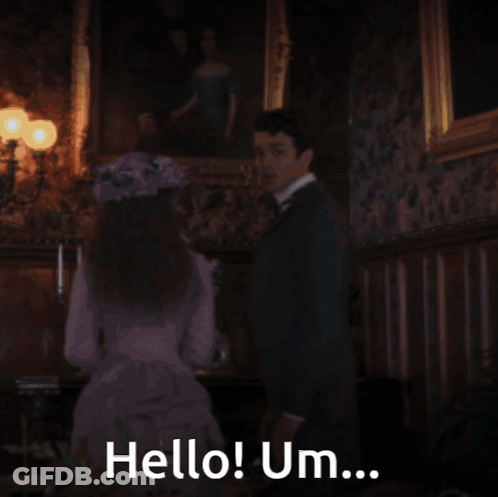 A Man In A Suit Is Saying Hello Um GIF