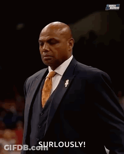 A Man In A Suit Is Saying " Surlously " In Front Of A Crowd GIF