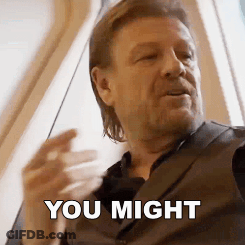 A Man In A Suit Is Saying You Might With His Hand GIF