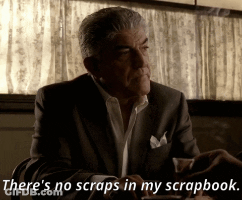 A Man In A Suit Is Sitting At A Table And Says There 'S No Scraps In My Scrapbook GIF
