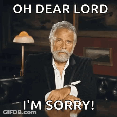 A Man In A Suit Is Sitting At A Table With The Words Oh Dear Lord I 'M Sorry Above Him GIF