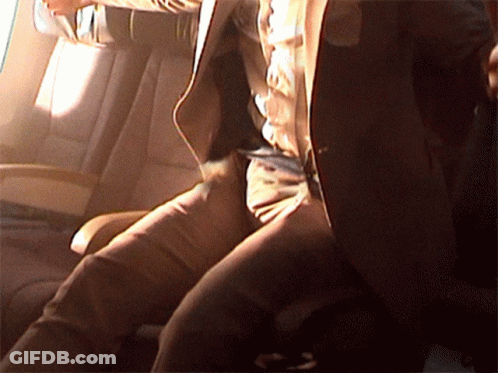 A Man In A Suit Is Sitting In A Car GIF
