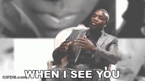 A Man In A Suit Is Sitting In A Chair And Saying When I See You GIF