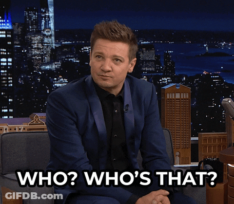 A Man In A Suit Is Sitting In A Chair And Says " Who Who 'S That " GIF