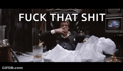 A Man In A Suit Is Sitting In A Chair Smoking A Cigarette And Drinking Whiskey . GIF