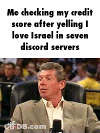 A Man In A Suit Is Sitting In A Chair With A Microphone In Front Of A Crowd . GIF