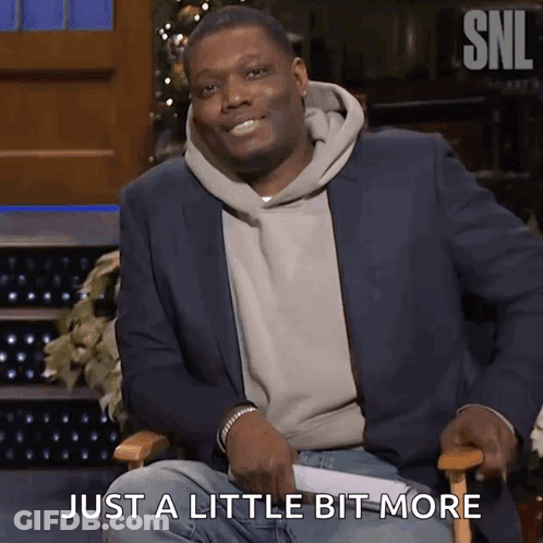 A Man In A Suit Is Sitting In A Chair With The Words Just A Little Bit More Behind Him GIF
