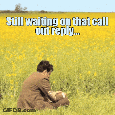 A Man In A Suit Is Sitting In A Field Of Yellow Flowers With A Caption That Says Still Waiting On That Call Out Reply GIF