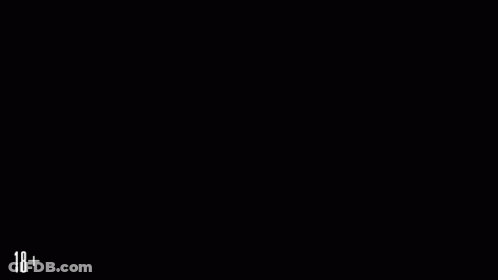 A Man In A Suit Is Sitting In Front Of A Fireplace With A Dog And A Candle With The Numbers 18+ GIF