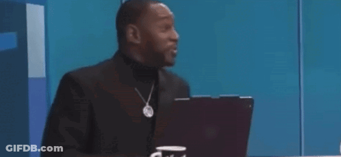 A Man In A Suit Is Sitting In Front Of A Laptop Computer And Says `` That Was Crazy '' . GIF