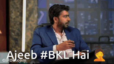 Man In Suit In Front Of Ajeeb Sign GIF