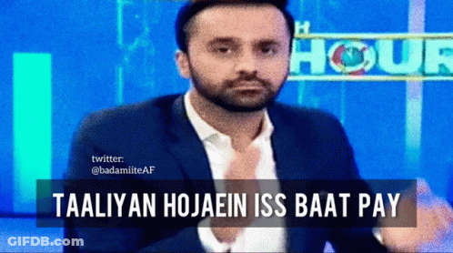 A Man In A Suit Is Sitting In Front Of A Sign That Says " Hour " GIF