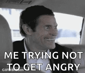 A Man In A Suit Is Sitting In The Back Seat Of A Car . GIF