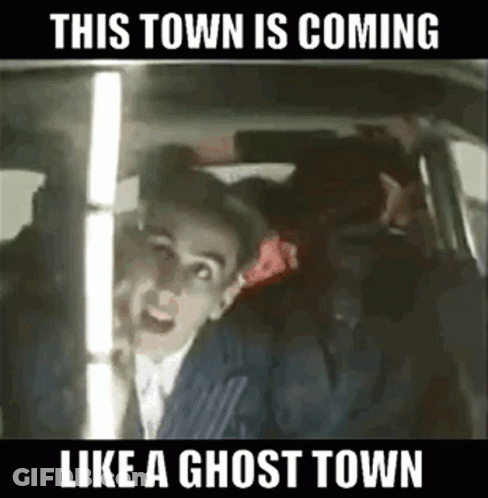 A Man In A Suit Is Sitting In The Back Seat Of A Car . GIF