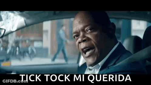A Man In A Suit Is Sitting In The Driver 'S Seat Of A Car And Yelling . GIF