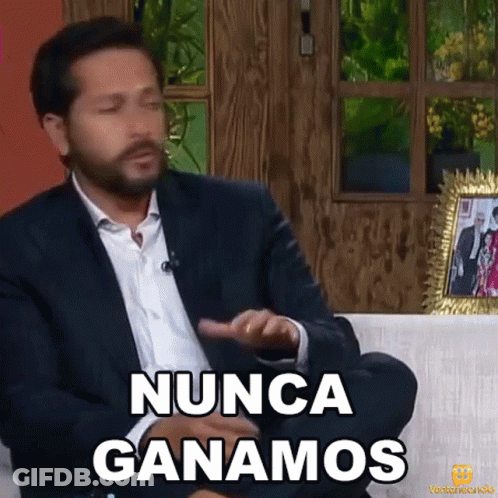 A Man In A Suit Is Sitting On A Couch And Saying " Nunca Ganamos " GIF