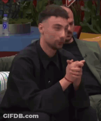 Man In Suit Sitting On Couch With Water Bottle GIF