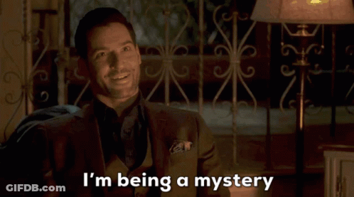 A Man In A Suit Is Smiling And Saying I 'M Being A Mystery GIF