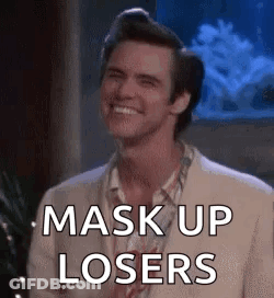 A Man In A Suit Is Smiling And Saying `` Mask Up Losers '' In Front Of An Aquarium . GIF