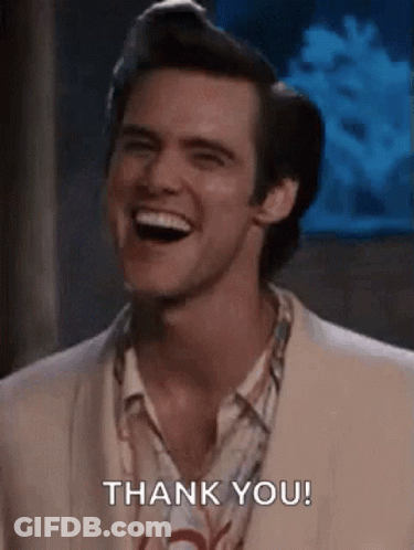 A Man In A Suit Is Smiling And Saying Thank You . GIF