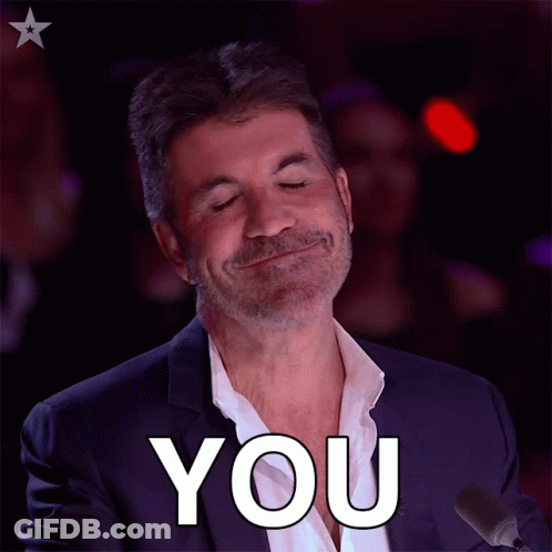A Man In A Suit Is Smiling And Says You GIF