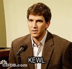 A Man In A Suit Is Speaking Into A Microphone And Says Kewl GIF