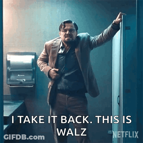 A Man In A Suit Is Standing In A Bathroom With The Words I Take It Back This Is Walz GIF