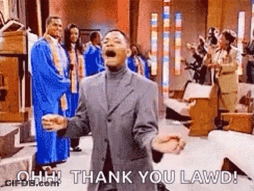 A Man In A Suit Is Standing In A Church With His Arms Outstretched And A Group Of People Behind Him . GIF