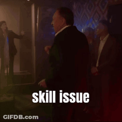 A Man In A Suit Is Standing In A Dark Room With The Words Skill Issue Written Above Him GIF