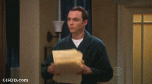 A Man In A Suit Is Standing In A Living Room With Papers Falling From The Ceiling GIF