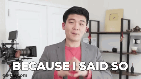 A Man In A Suit Is Standing In Front Of A Camera With The Words `` Because I Said So '' Written On His Face . GIF