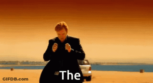 A Man In A Suit Is Standing In Front Of A Car With The Word The Written On The Screen GIF