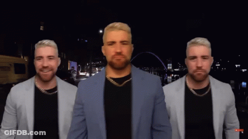 A Man In A Suit Is Standing In Front Of A City Skyline GIF