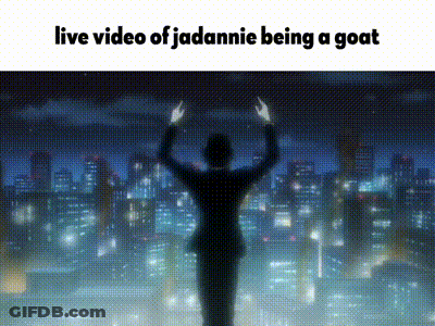 A Man In A Suit Is Standing In Front Of A City Skyline With His Hands In The Air . GIF