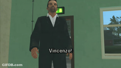 A Man In A Suit Is Standing In Front Of A Door And Says " Vincenzo " GIF