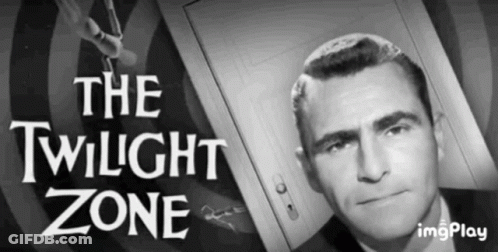 A Man In A Suit Is Standing In Front Of A Door With The Words The Twilight Zone Above Him . GIF