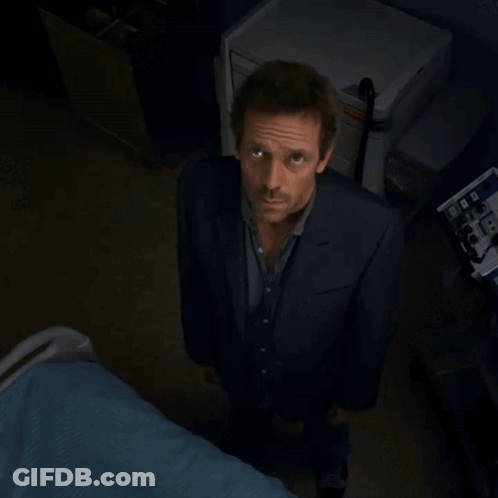 A Man In A Suit Is Standing In Front Of A Machine That Says ' Ecg ' On It GIF
