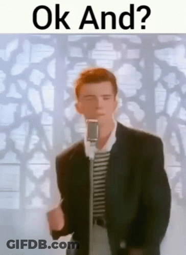 A Man In A Suit Is Standing In Front Of A Microphone And Singing . GIF