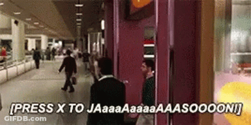 A Man In A Suit Is Standing In Front Of A Phone Booth That Says Press X To Jaaaa GIF