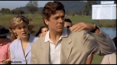 A Man In A Suit Is Standing In Front Of A Scoreboard That Says ' Masters ' GIF