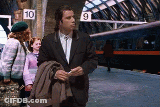 A Man In A Suit Is Standing In Front Of A Sign That Says 10 GIF