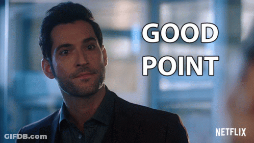 A Man In A Suit Is Standing In Front Of A Sign That Says " Good Point " GIF