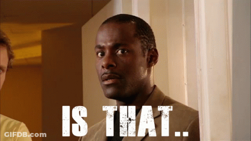 A Man In A Suit Is Standing In Front Of A Sign That Says " Is That " GIF