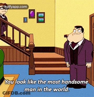 A Man In A Suit Is Standing In Front Of A Staircase And Says You Look Like The Most Handsome Man In The World GIF