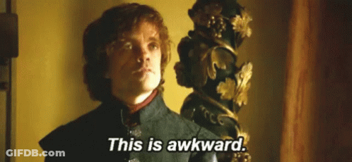 A Man In A Suit Is Standing In Front Of A Statue And Says `` This Is Awkward '' . GIF