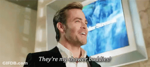A Man In A Suit Is Standing In Front Of A Television And Says They 'Re My Shower Buddies ! GIF